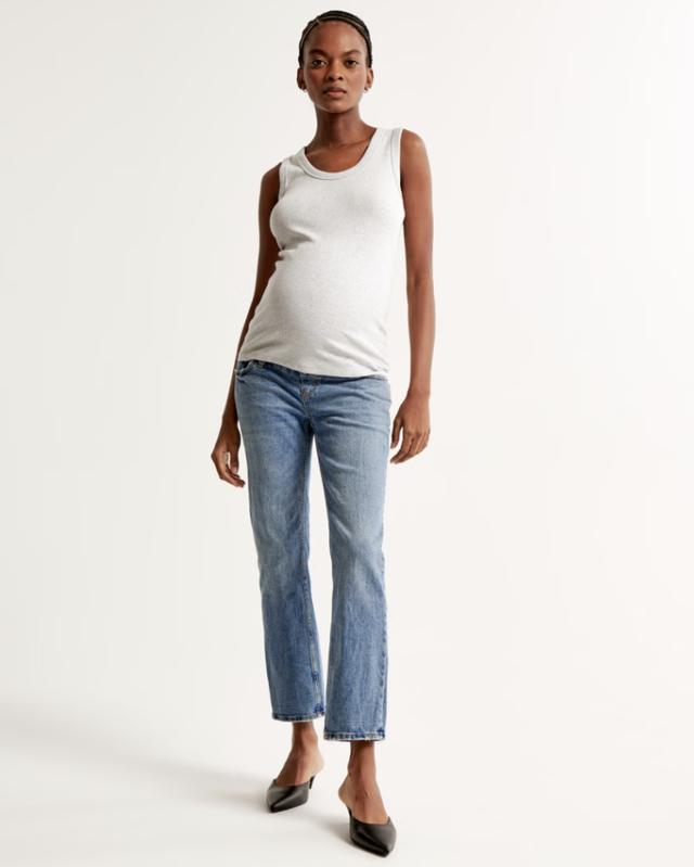 A woman wearing the Abercrombie & Fitch Maternity Ankle Straight Jean on a white background