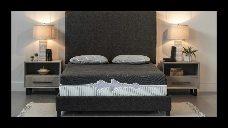 The GoodVibeSleep Adjustable Mattress on its adjustable base in a bed frame in a bedroom