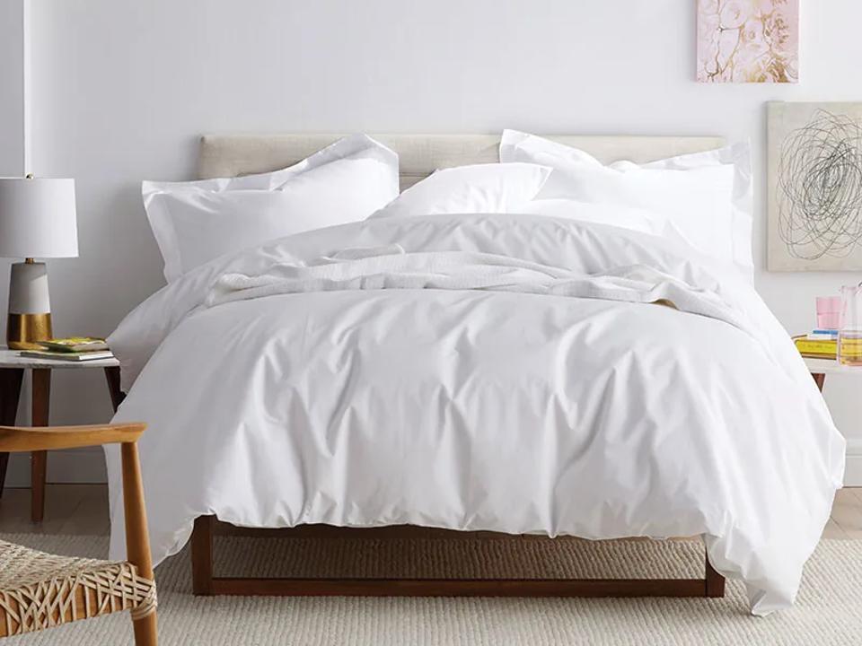 Lifestyle shot of white Company Cotton Classic Cool Cotton Percale Sheet Set in a bedroom.