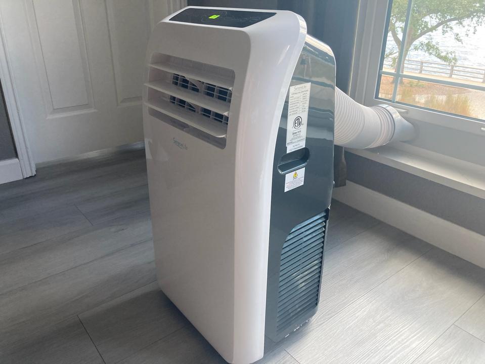 original photo of white & gray Serene Life SLPAC10 Portable AC in sunlit room in florida home