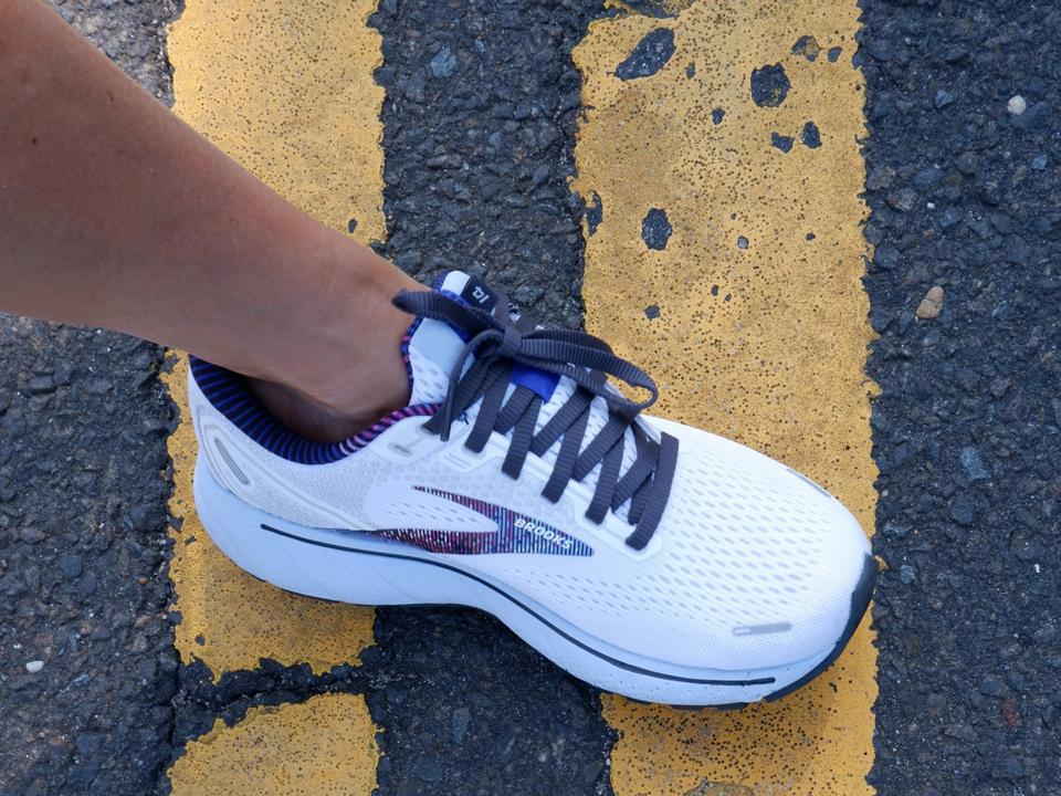 white pair of brooks ghost 14 on the road