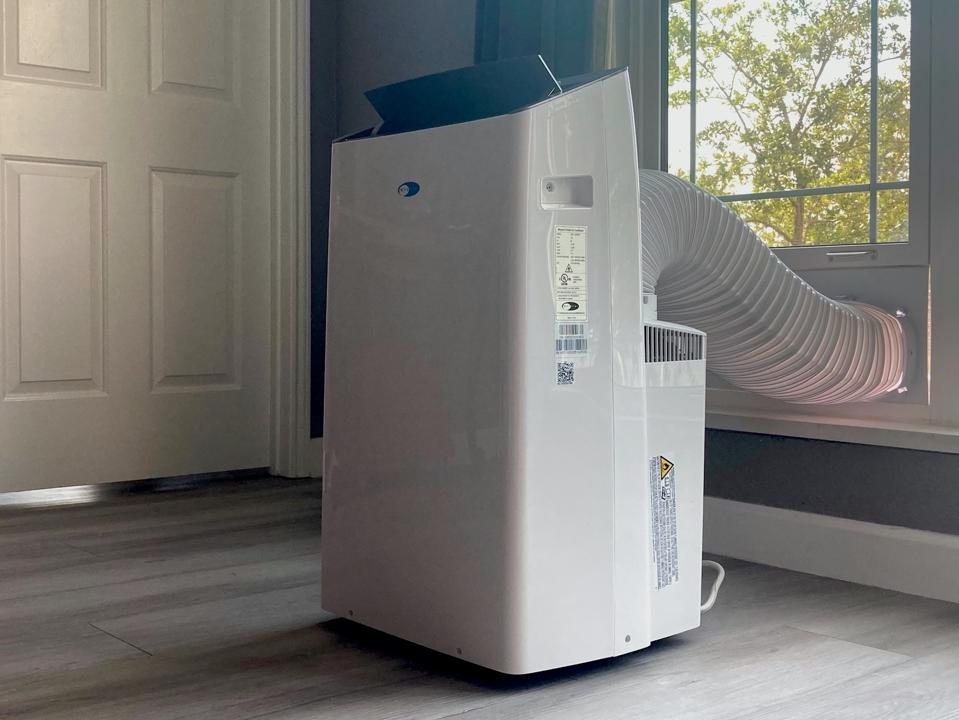 The Whynter ARC-1230WN white portable air conditioner installed in room in daytime air conditioner