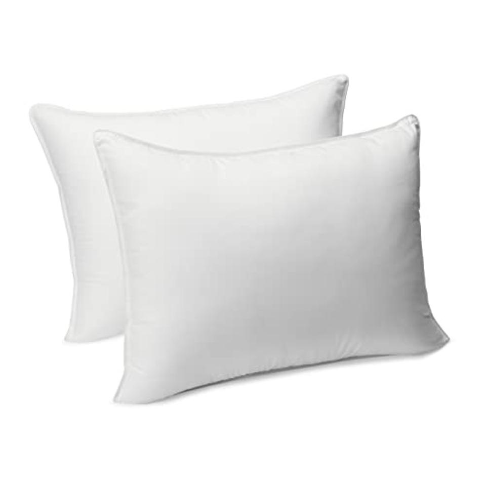 Two Amazon Basics Down Alternative Bed Pillows seen side by side on white background.