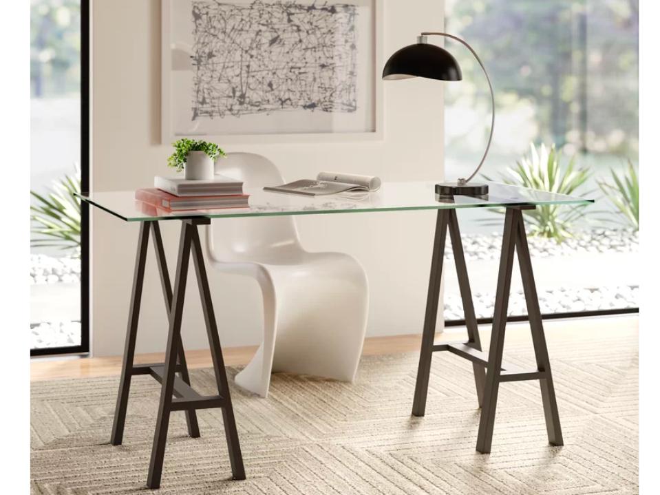 Best Desk: The Joss and Main Lexus Glass Desk pictured in a patterned vintage-style rug, placed in front of an upholstered office chair. 