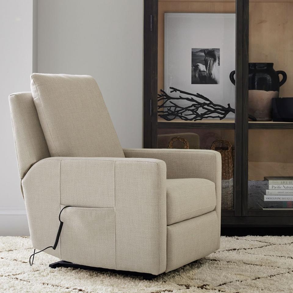 A tan Ayden Power Lift Recliner in a study in front of a bookcase.