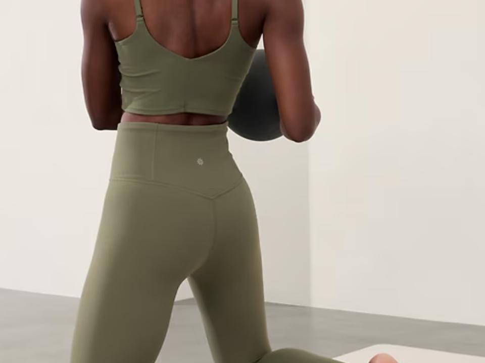 Person working out in the green elation high rise legging from Athleta.