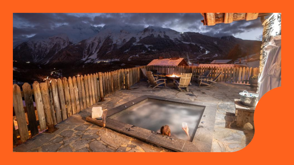 A person sitting on a hot tub in the mountains