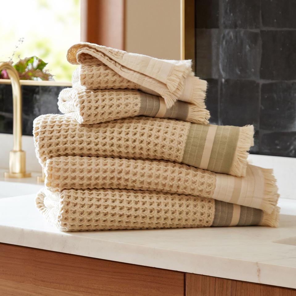 Rejuvenation Waffle Knit Stripe Organic Cotton Towels on a marble sink.