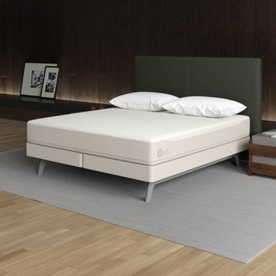 The Sleep Number p6 Smart Bed in a tan and brown bedroom. 