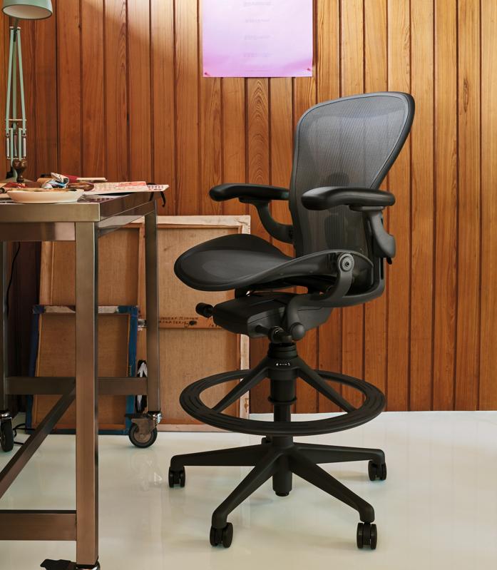 The Herman Miller Aeron Stool in a wood-paneled office