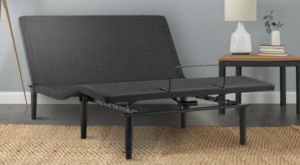 The Sealy Adjustable Bed Frame on top of a rattan-type rug