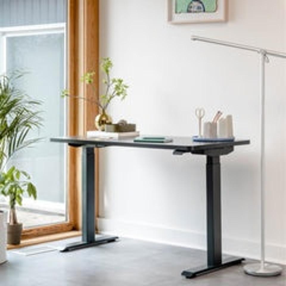 Branch Duo Standing Desk against a white wall