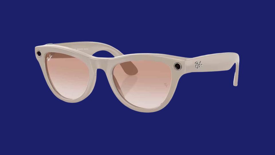 Ray-Ban Meta smart glasses in Shiny Chalky Gray on a navy background.