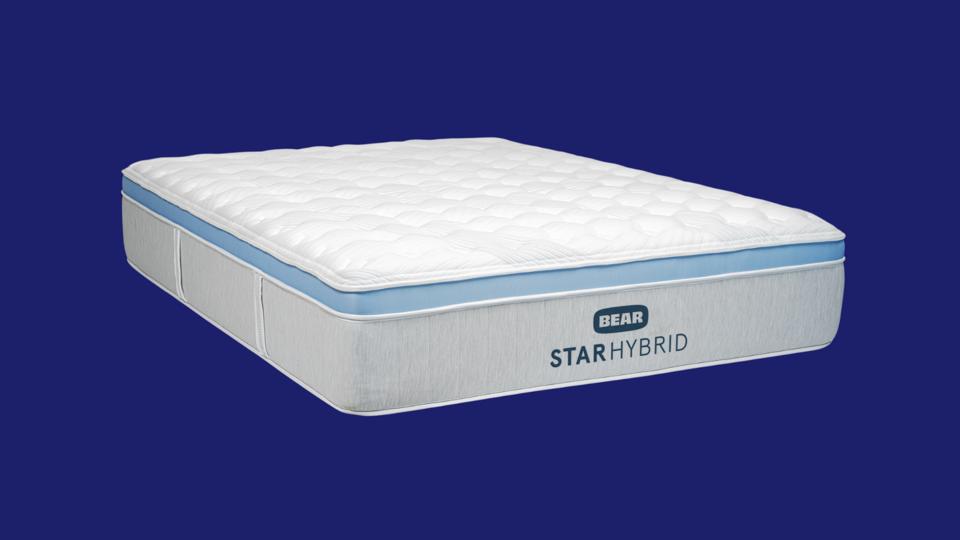 The Bear Star Hybrid mattress against a solid blue background.