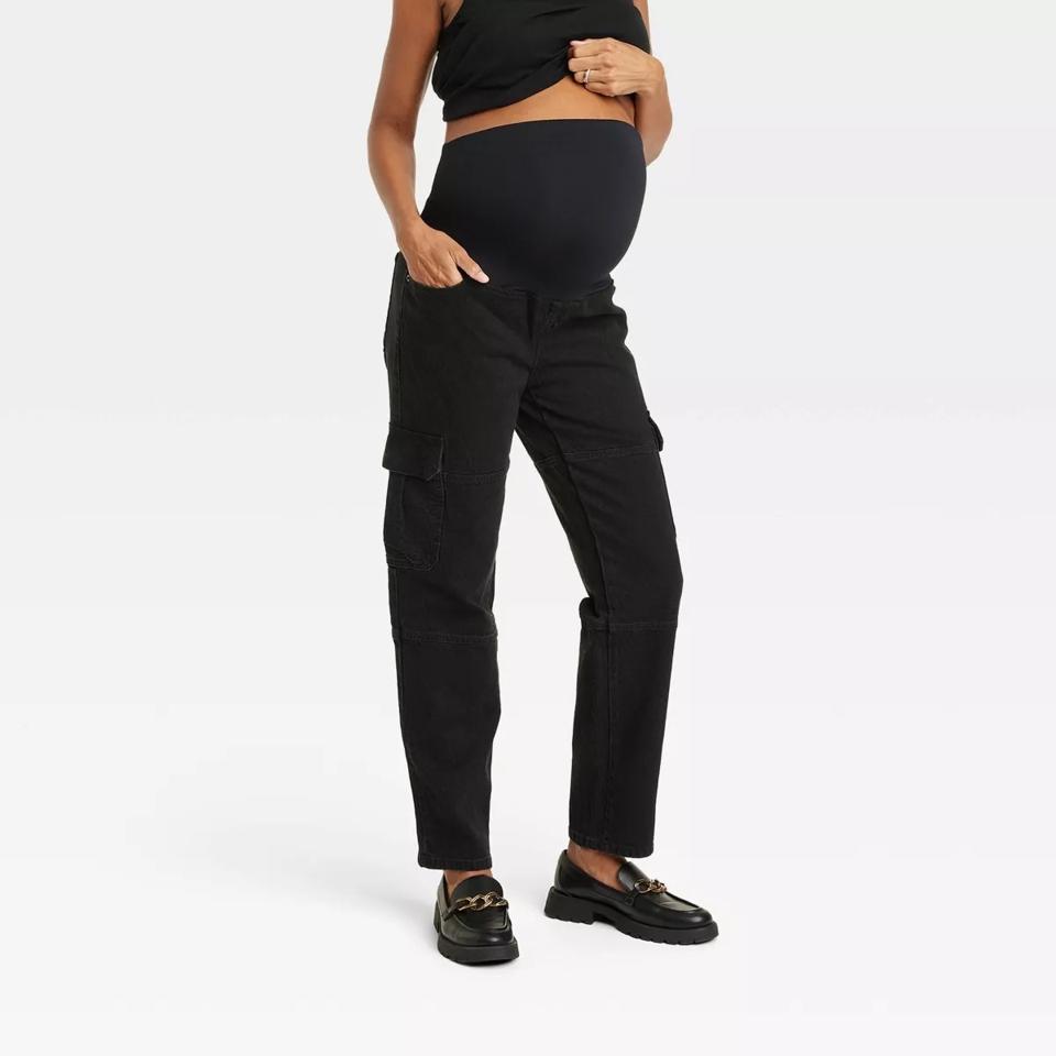 A woman wearing the Ingrid & Isabel Over Belly 90's Straight Maternity Jeans in black