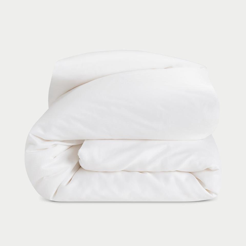 The Cozy Earth Bamboo Viscose Comforter folded up on a white background. 