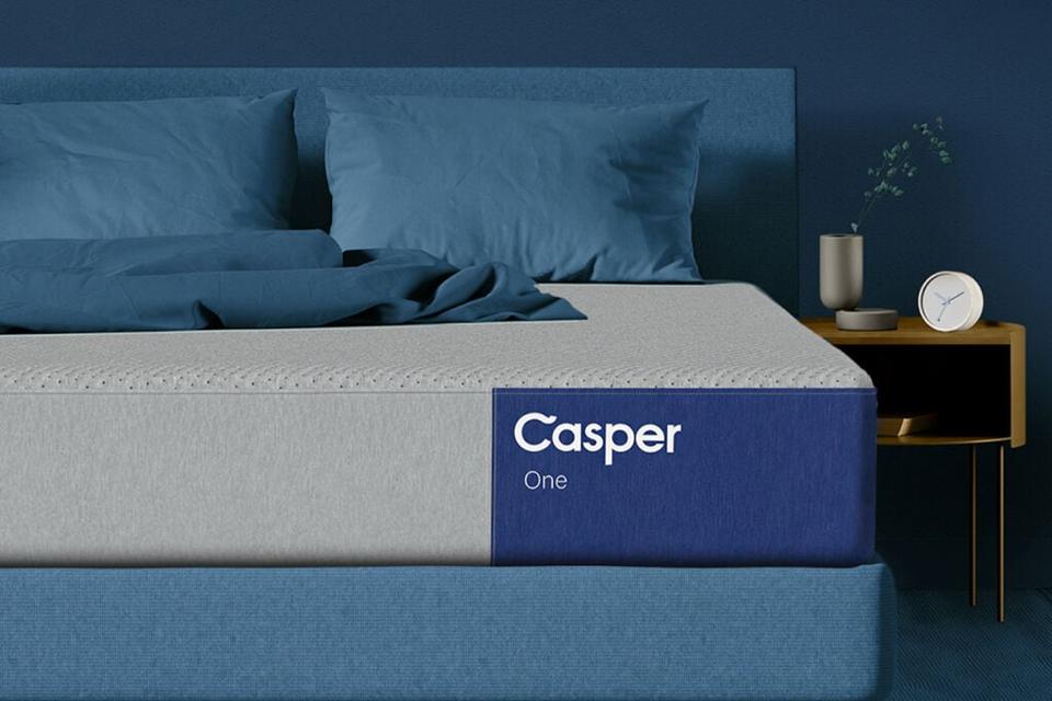 Casper One Mattress (Queen) in a blue room with a nightstand.