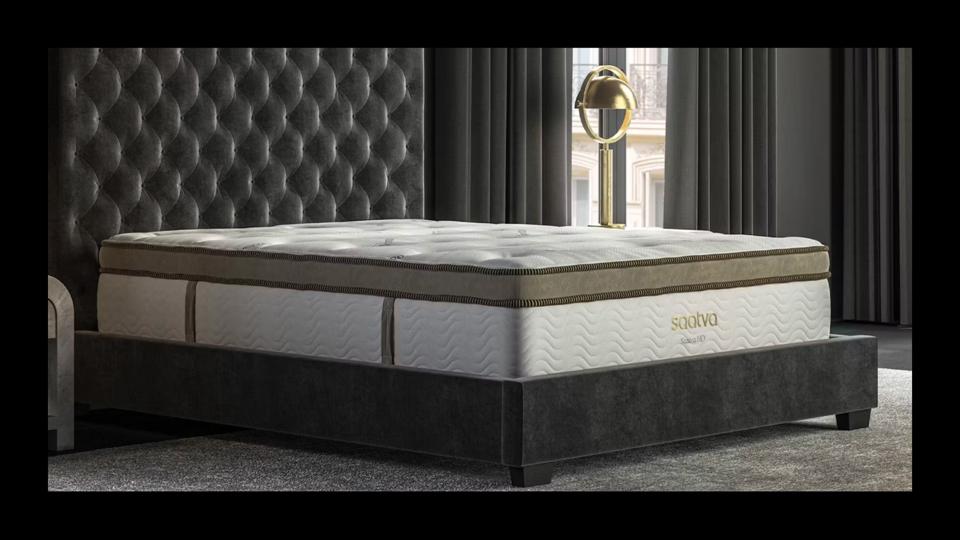 The Saatva HD mattress on a dark grey bedframe.