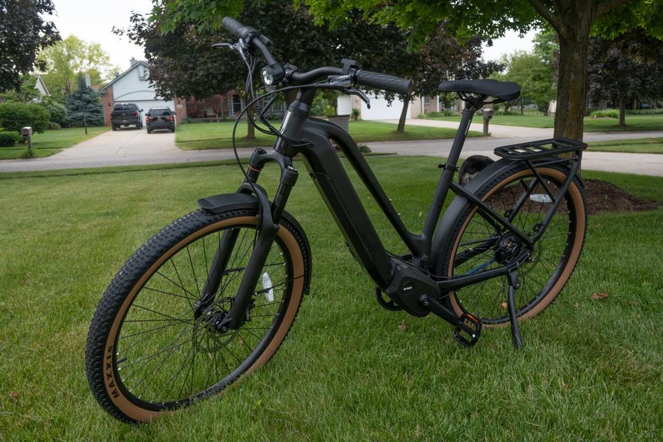 The Ride1up Prodigy V2 ebike sitting on a green lawn in a suburban neighborhood