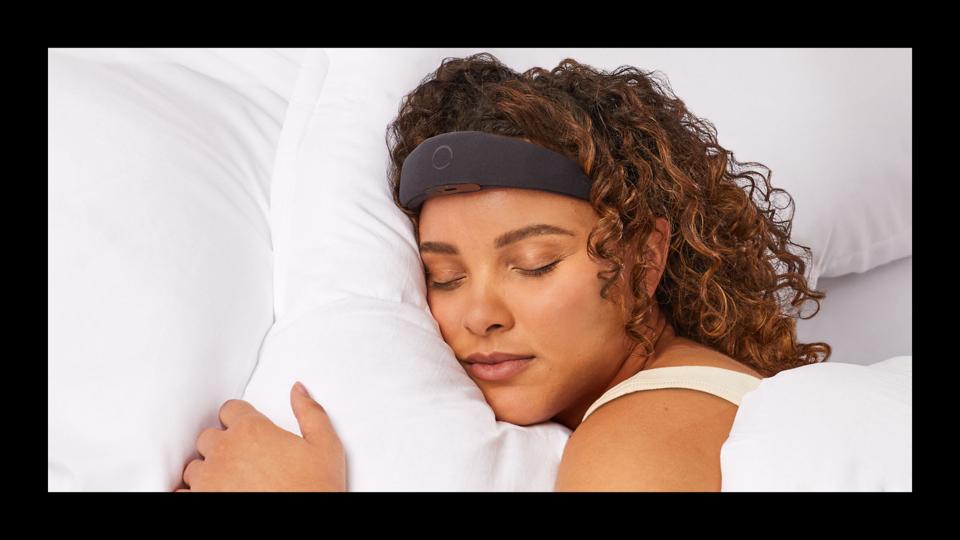 A woman wearing the Elemind headband while sleeping with a black border