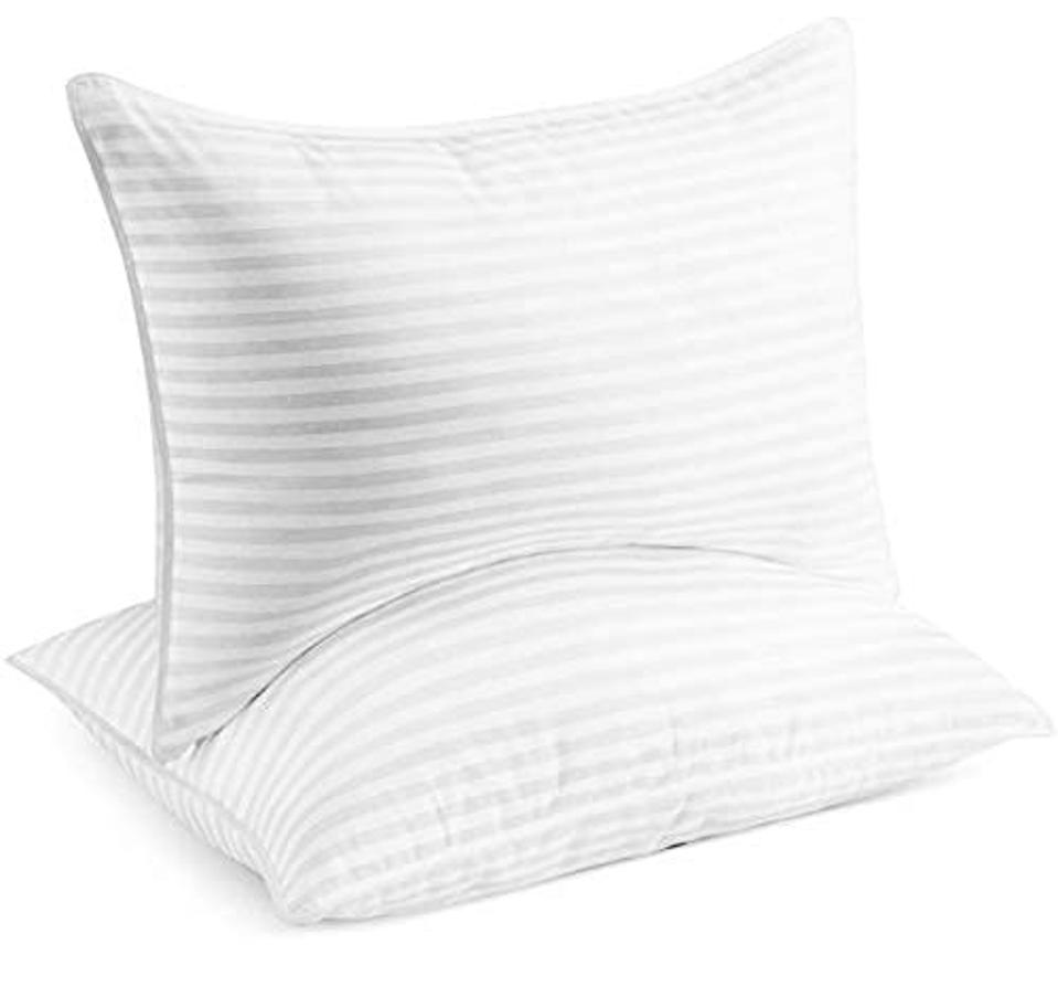 Two white Beckham Hotel Collection Bed Pillows on a white background