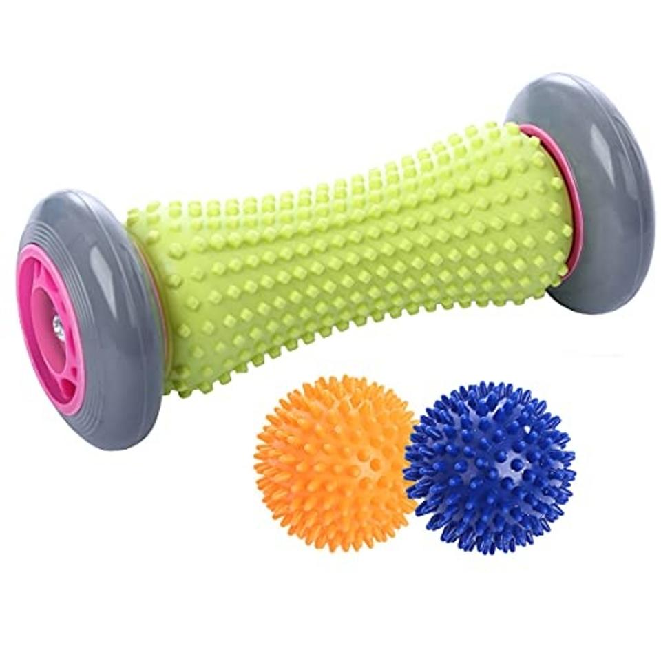 green, grey and pink roller with blue and orange spiky balls on a white background