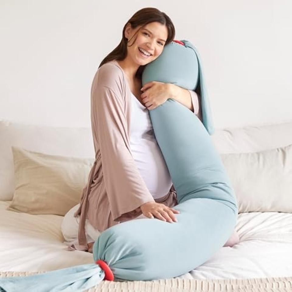 Pregnant woman holding the bbhugme Adjustable Pregnancy Pillow