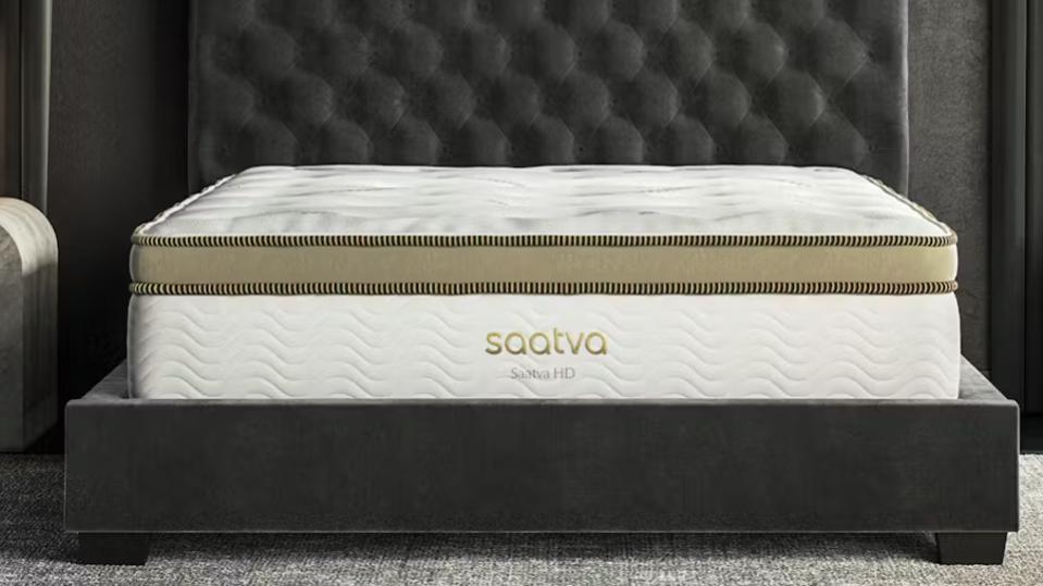 The Saatva HD mattress on a dark grey bed frame.