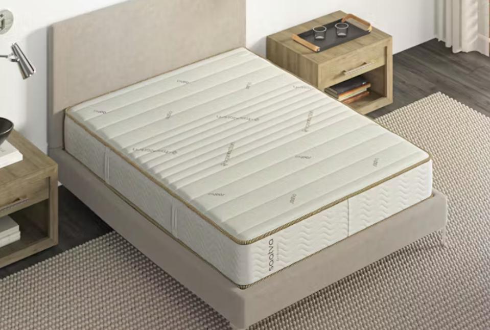 The Saatva Zenhaven Mattress from a bird's eye view on a bed frame in a bedroom