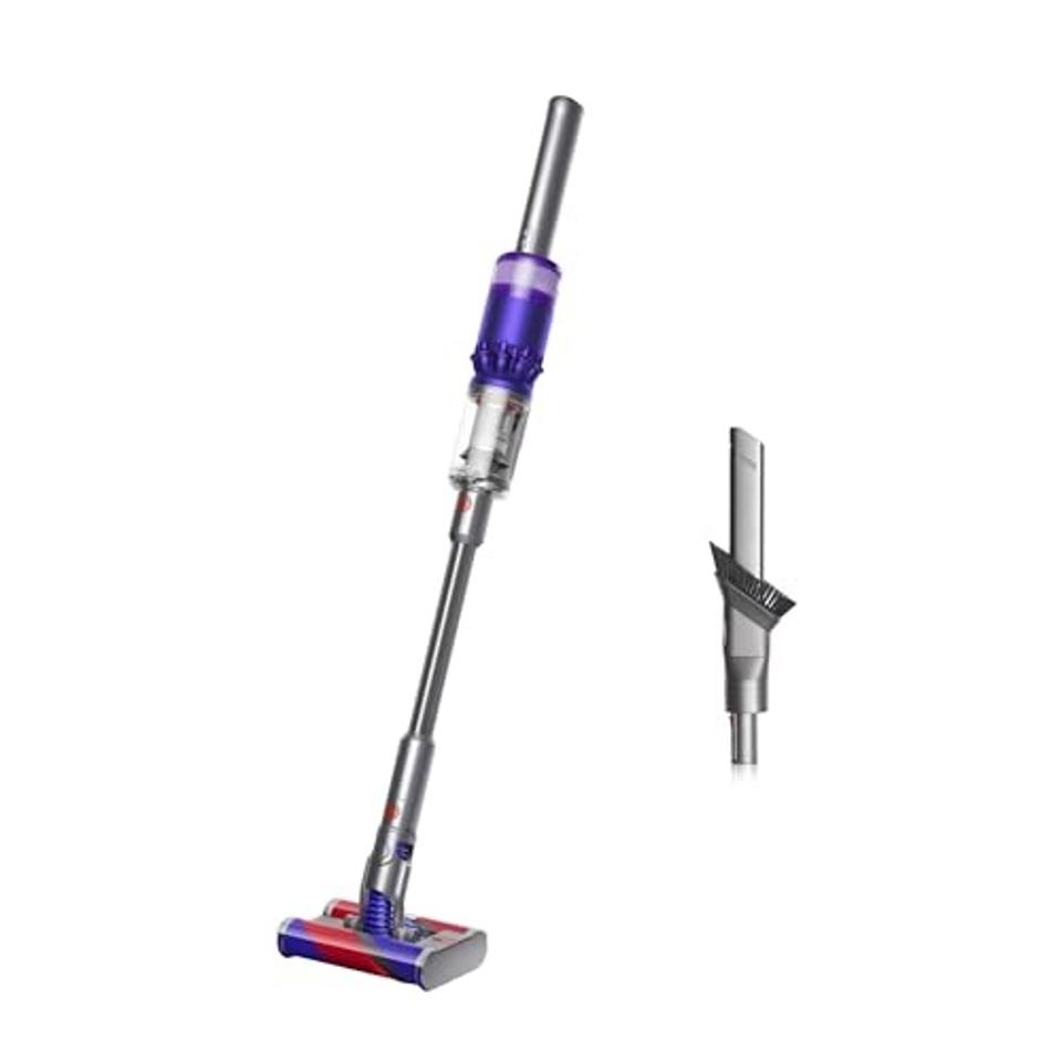 The Dyson Omni-glide Cordless Vacuum Cleaner with a part next to it on a white background