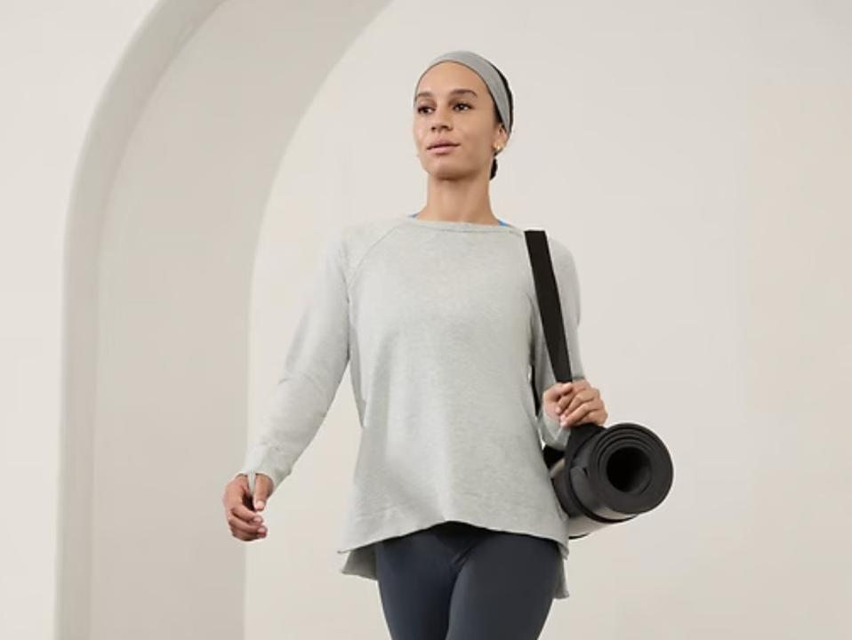 Woman walking while wearing the Athleta Coaster Luxe Recover Sweatshirt