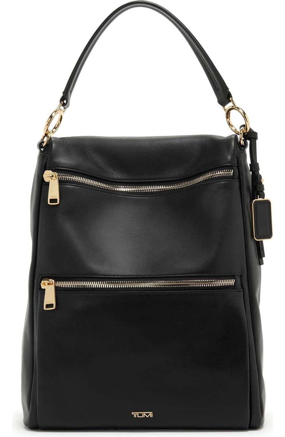 Product shot of black leather Tumi Liv Convertible Tote with gold zipper and metal details