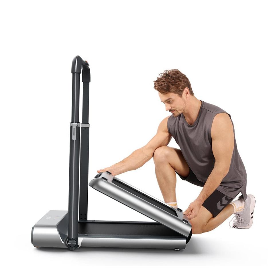 Man folding a WalkingPad R1 Pro 2-In-1 Foldable Treadmill on a white background.