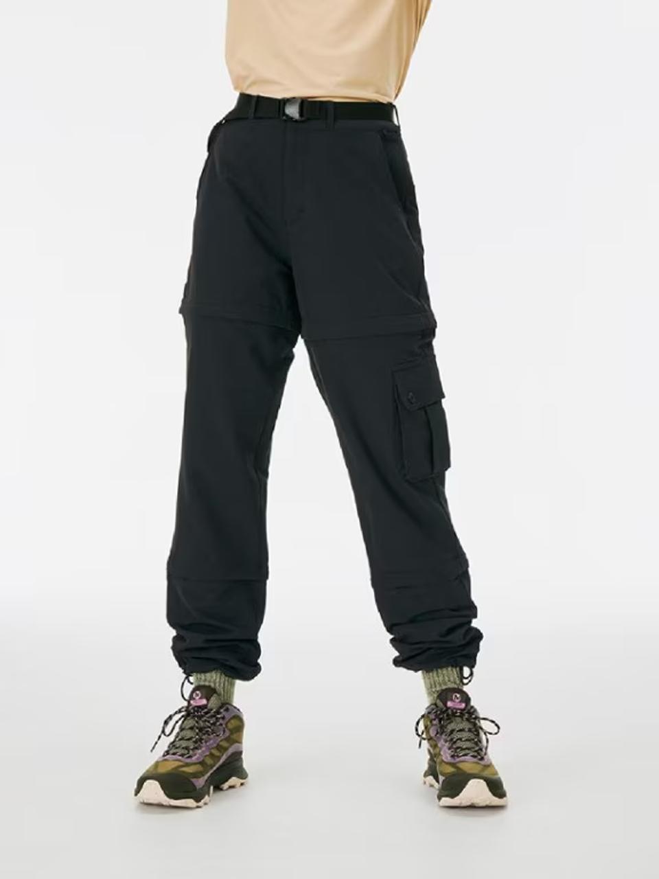 A woman wearing Outdoor Voices RecTreck Zip-Off Pants against a white background. 