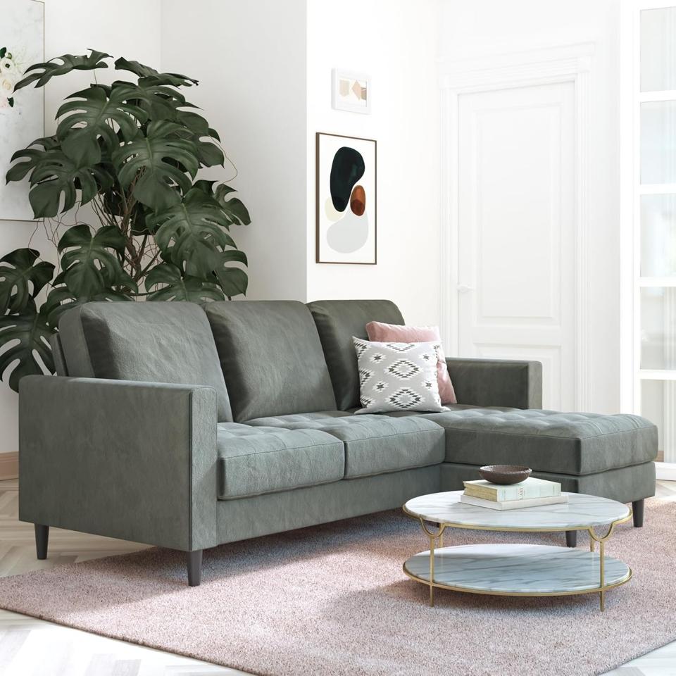 CosmoLiving by Cosmopolitan Strummer Sectional in a living room with pink rug.