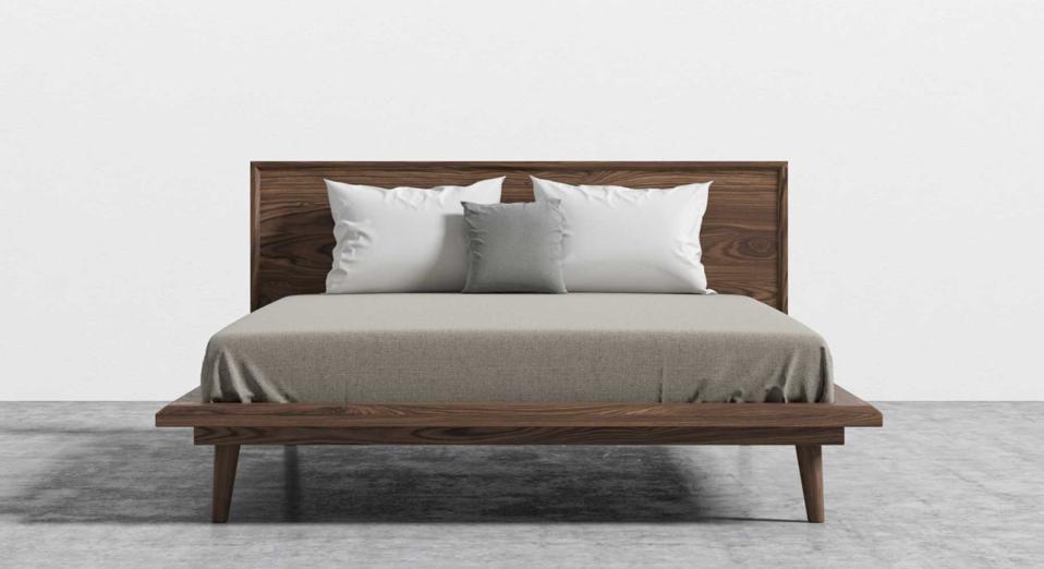 A Rove Concepts Wooden Bed Frame with a made mattress on top. 