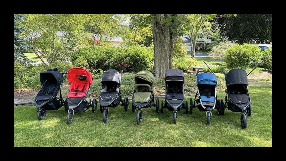 photo 7 jogging/running strollers lined up outside in daytime in front of a tree on grass