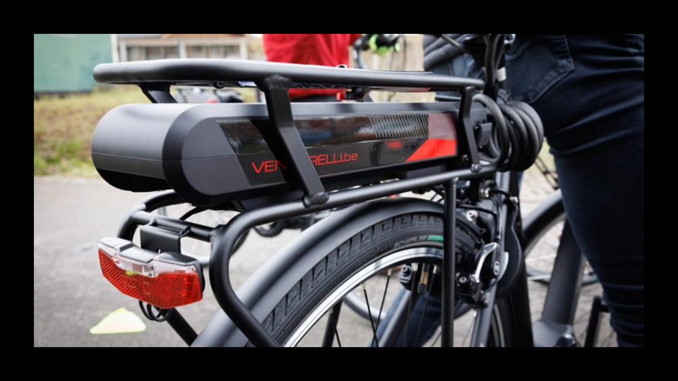 An electric bike battery on the back of an electric bike