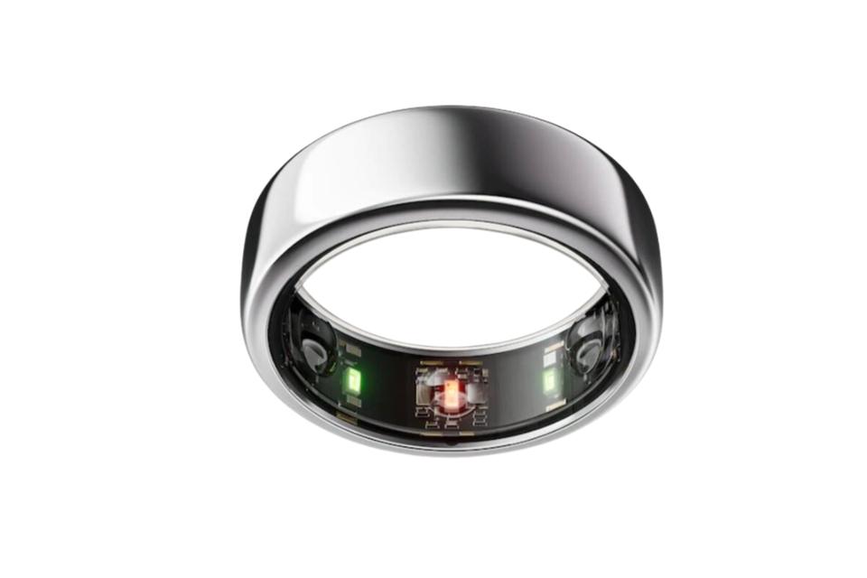 Oura Ring in silver on a tan background.