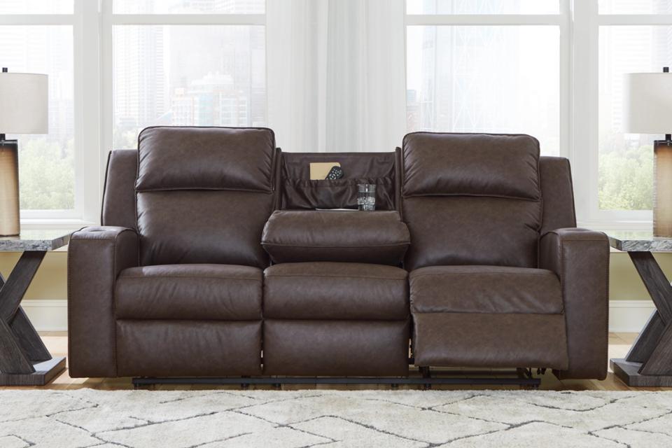 dark brown Lavenhorne Manual Reclining Sofa with Drop Down Table in living room in daytime