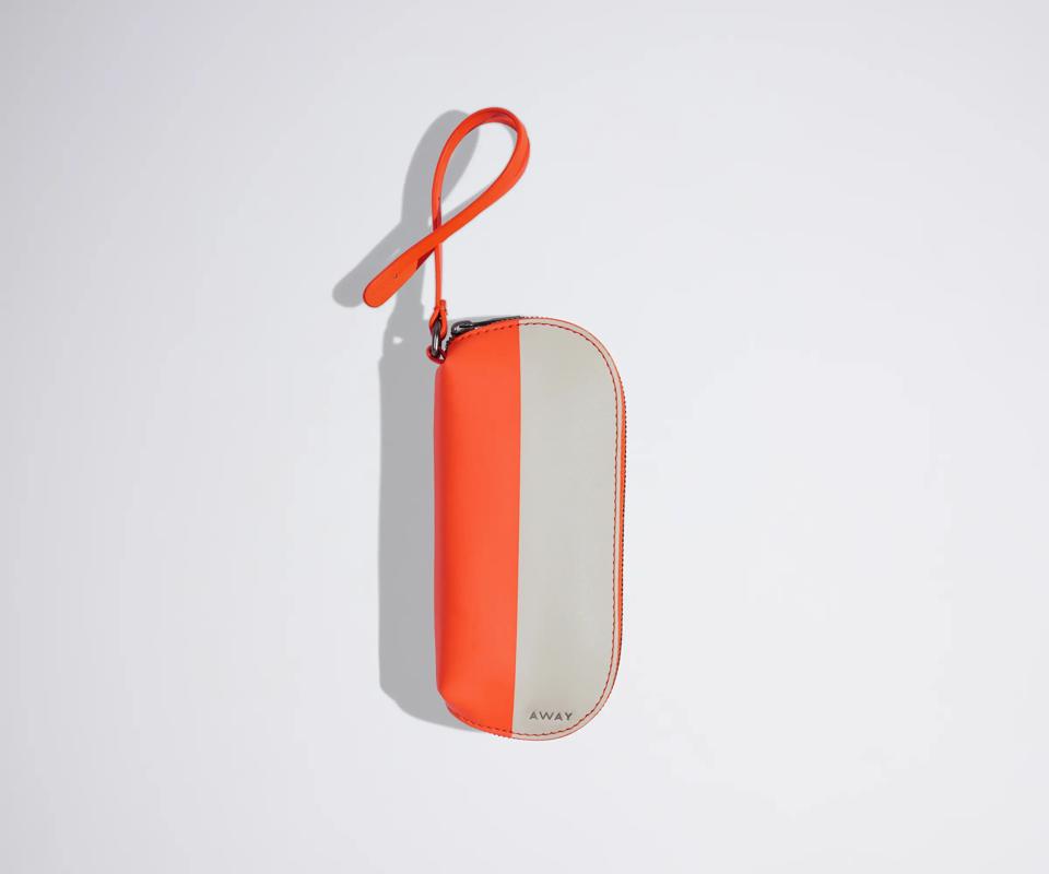 A white and orange striped sunglasses pouch.