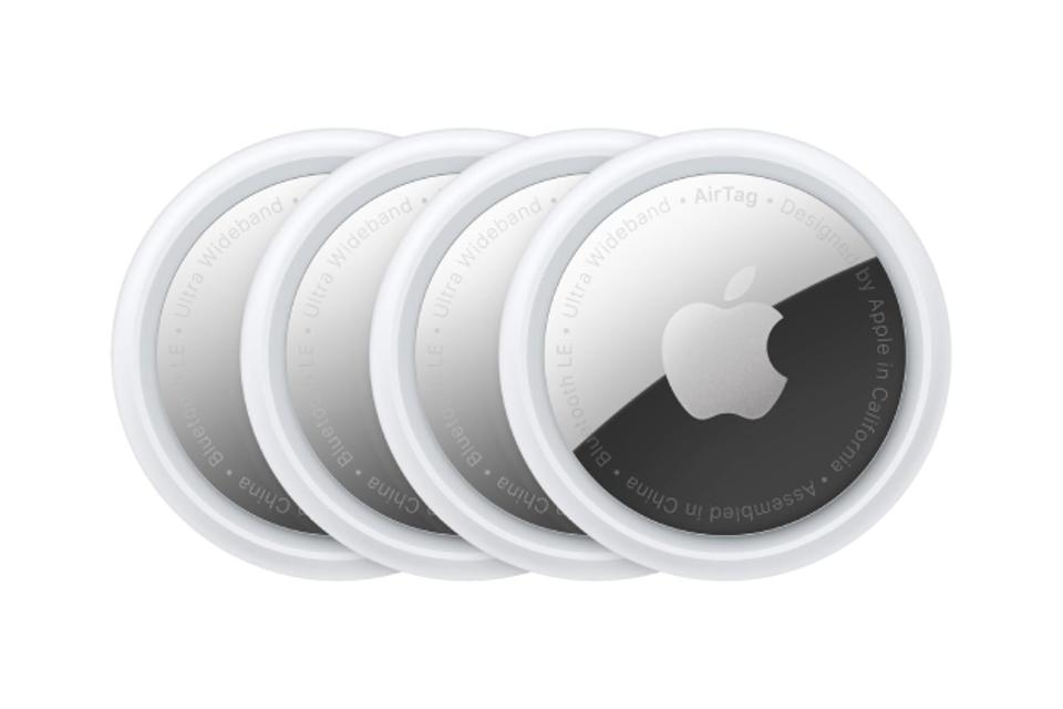 4 Apple AirTags against a white background.