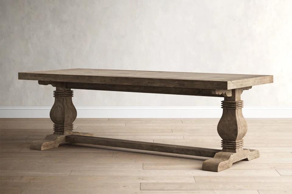 The Kinston Dining Table on a wooden floor