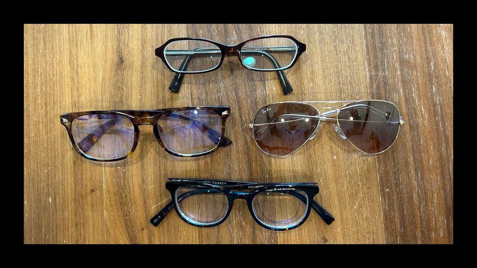 Four of our top prescription glasses options on a wooden table