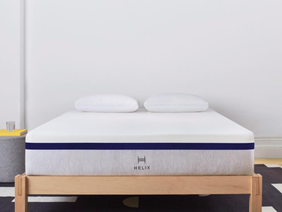 Helix Midnight Mattress on a wooden bedframe against a white wall