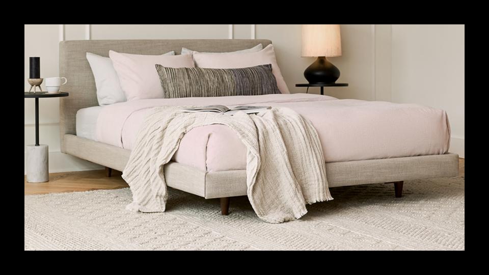 the Article Tessu Bed Frame in clay taupe set up in a bedroom