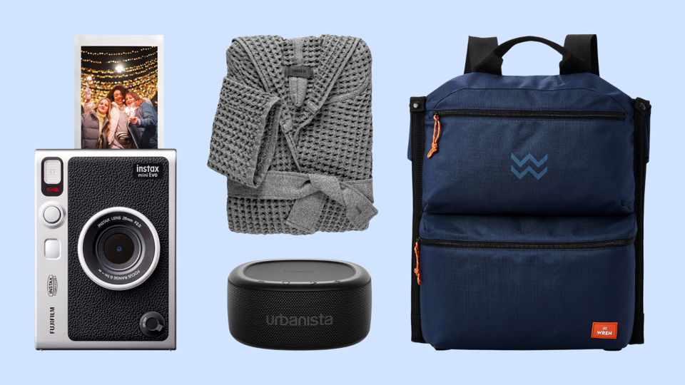 An instant camera, gray bathrobe, portable speaker and cooler bag on a blue background