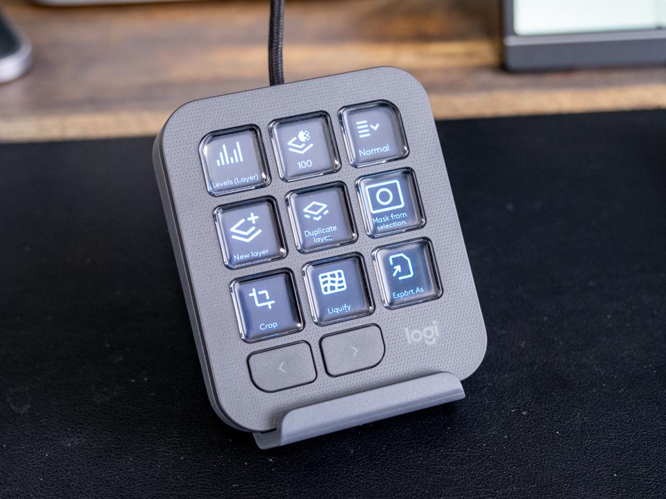 A Logitech MX Creative Keypad on a black pad.