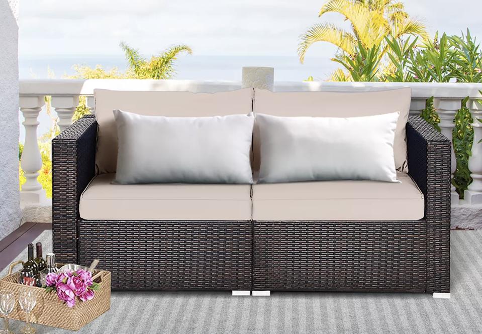 Lifestly shot of Costway 2-Piece Patio Rattan Corner Sofa on a patio outside.