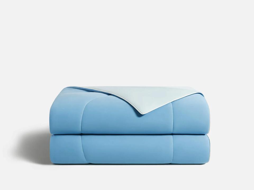 Rest Evercool Cooling Comforter in Aqua Blue folded on a white background